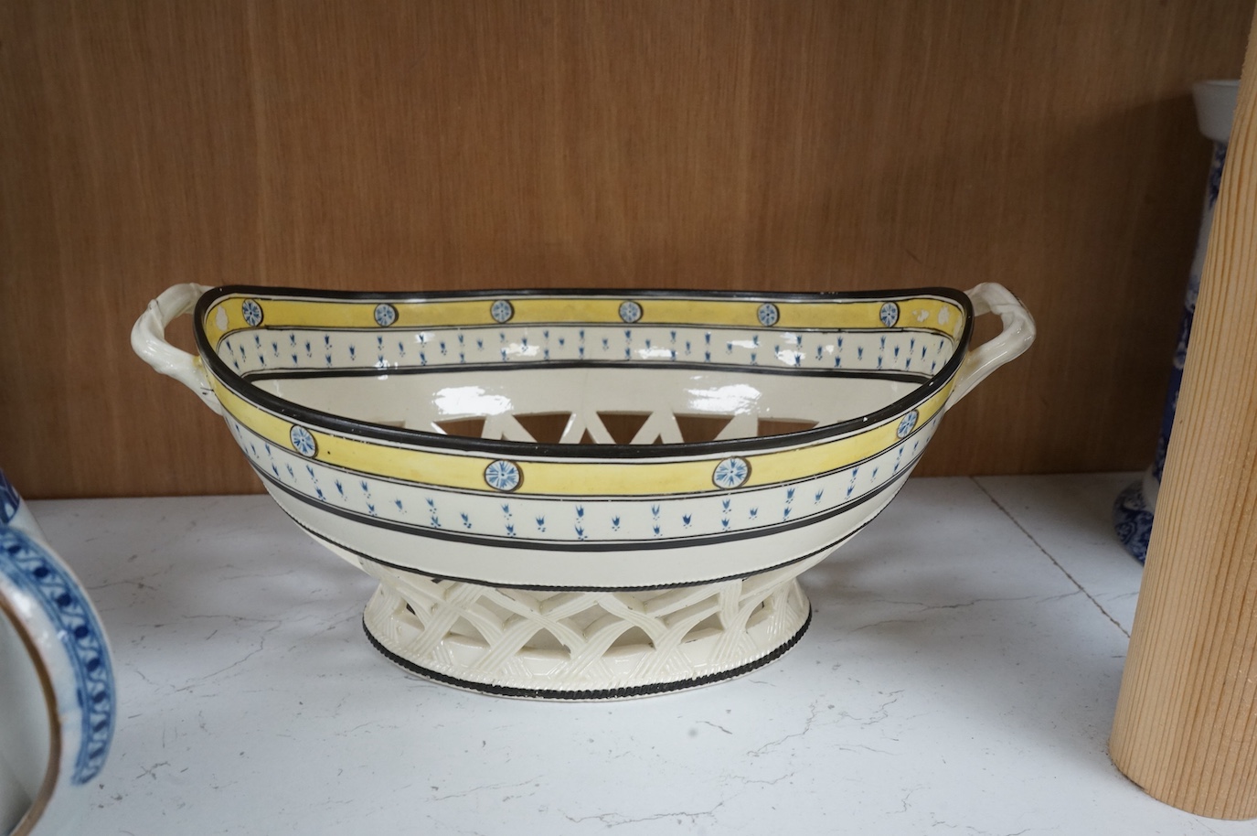 A George III creamware basket, a pearlware mug and jug, a Coalport spill vase (four), basket 26.5cm handle to handle.